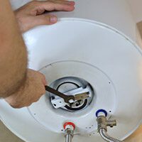 Technician working on a water heater