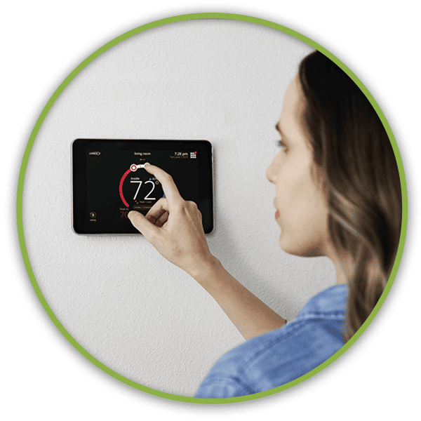 Woman adjusting her thermostat