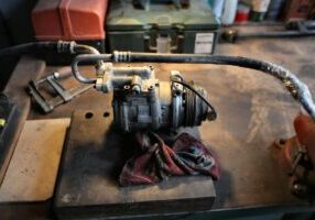 an ac compressor on a workbench